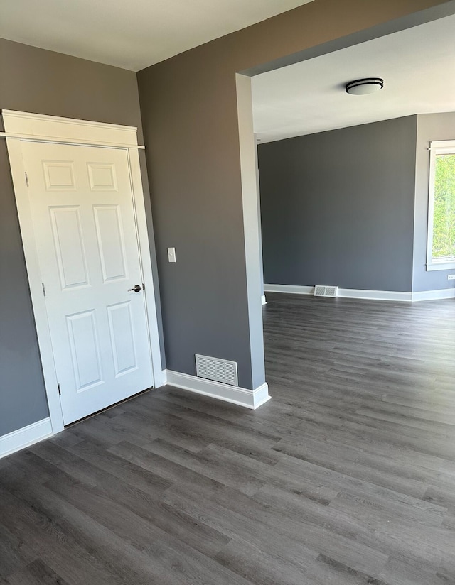 empty room with dark wood-type flooring