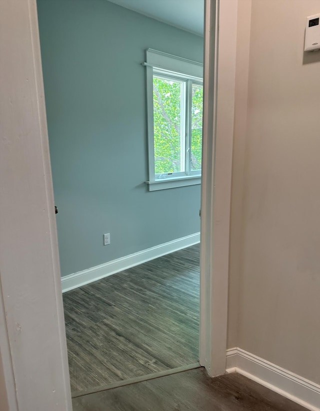 spare room with dark hardwood / wood-style flooring