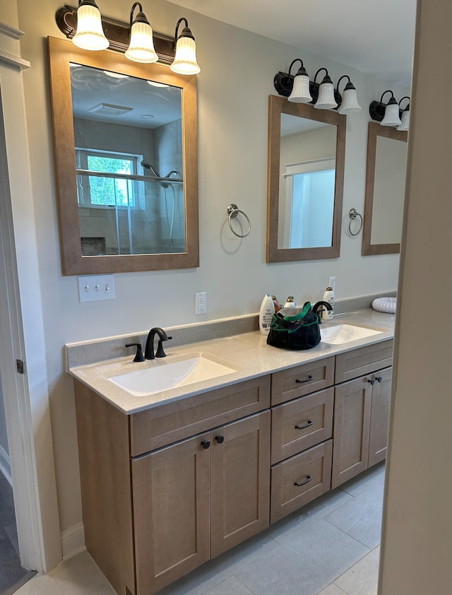 bathroom with dual sinks, vanity with extensive cabinet space, and tile flooring