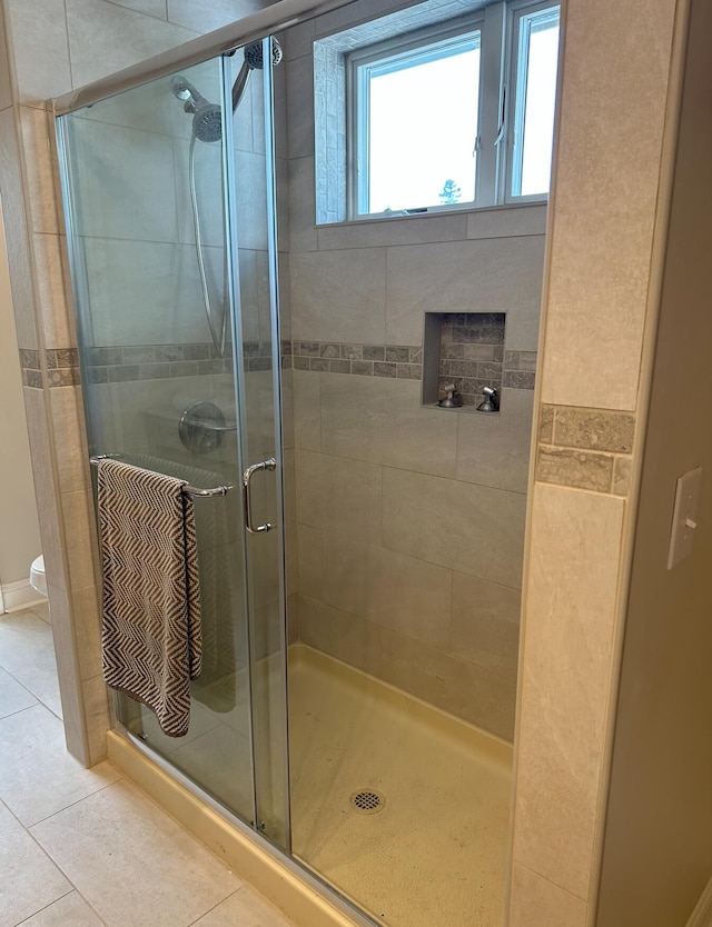 bathroom featuring toilet, tile flooring, and walk in shower