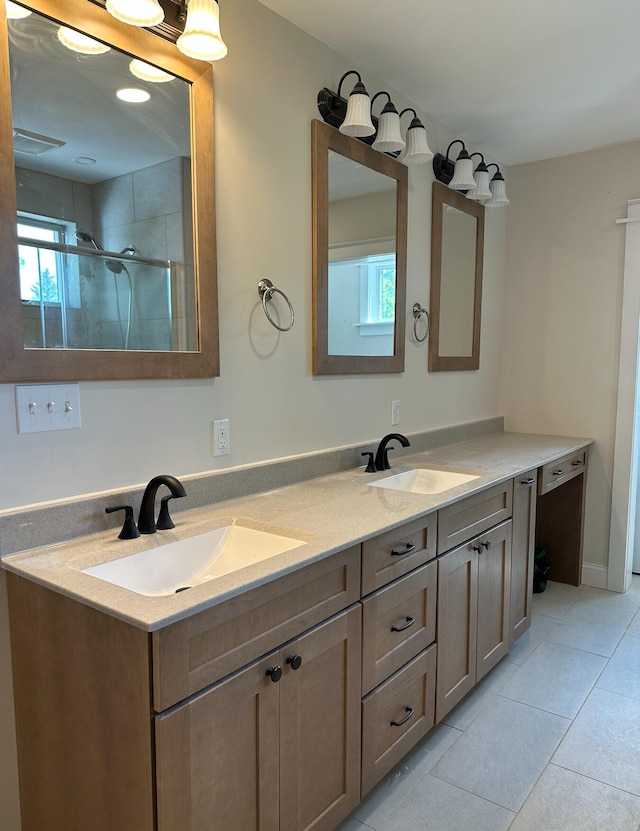 bathroom featuring plenty of natural light, dual sinks, tile flooring, and large vanity