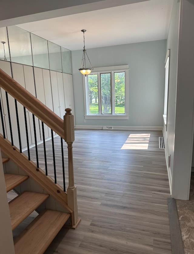 stairway with dark hardwood / wood-style flooring