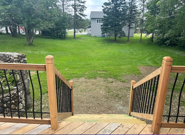 exterior space featuring a deck and a lawn