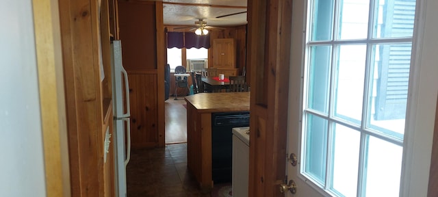 hallway featuring a healthy amount of sunlight, washer / clothes dryer, and dark tile flooring