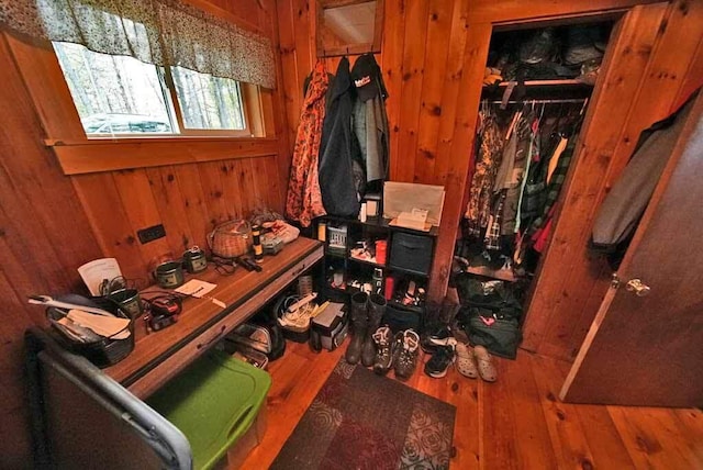 interior space featuring wood walls and hardwood / wood-style flooring