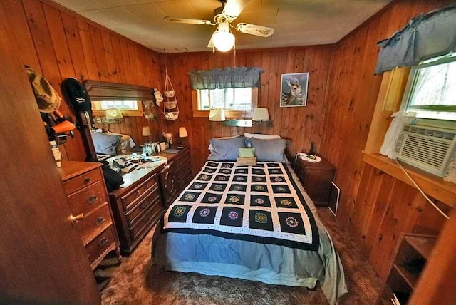 bedroom featuring multiple windows and wooden walls