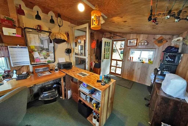 office space with dark carpet and wooden walls