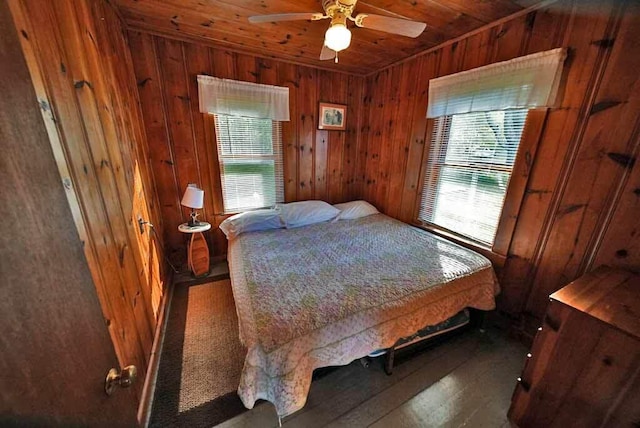 bedroom featuring wood walls, ceiling fan, multiple windows, and wood ceiling