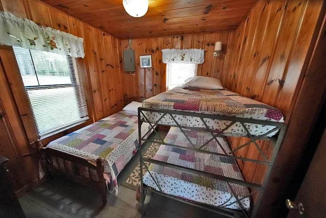 bedroom with wooden walls and wooden ceiling