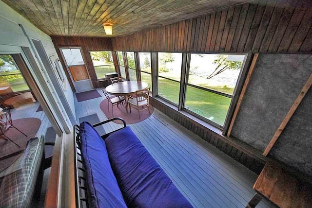 sunroom featuring wood ceiling and lofted ceiling