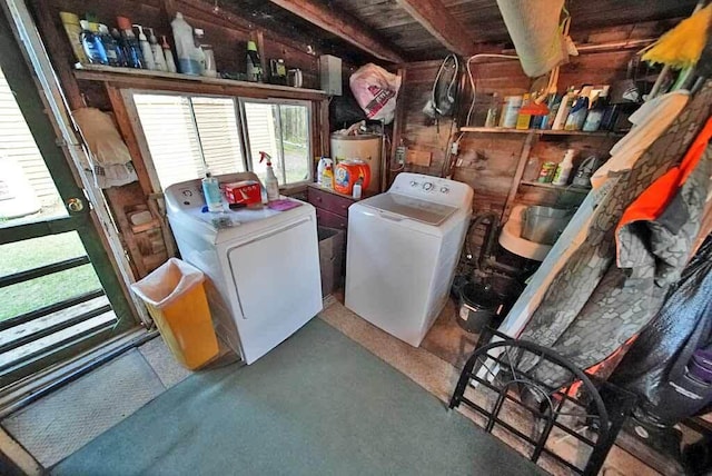 storage room with water heater and washer and dryer