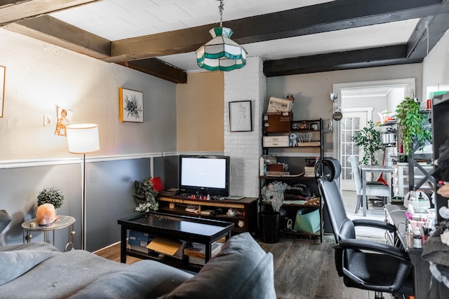 living room featuring beamed ceiling and hardwood / wood-style flooring