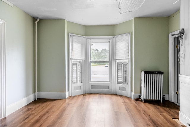 entryway with wood-type flooring and radiator