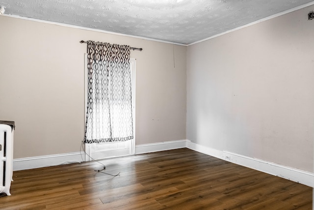 unfurnished room with ornamental molding, a textured ceiling, and hardwood / wood-style flooring