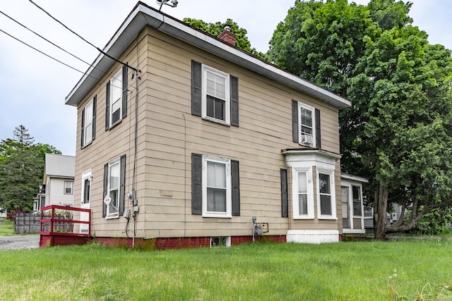 back of house featuring a yard