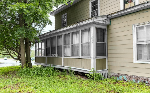 view of side of home with a sunroom