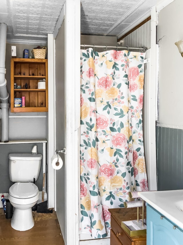 bathroom featuring toilet, crown molding, vanity, hardwood / wood-style flooring, and a shower with curtain