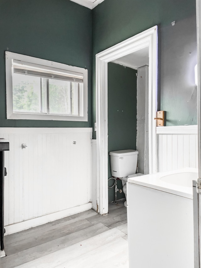 bathroom featuring toilet and wood-type flooring