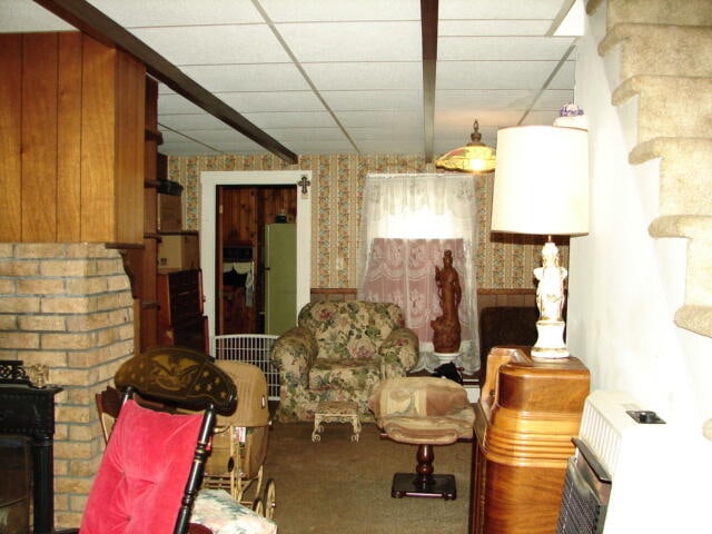 miscellaneous room featuring a paneled ceiling and carpet flooring