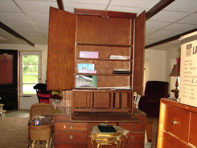 interior space with carpet floors and a paneled ceiling