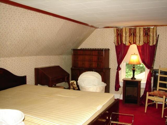 bedroom with crown molding and carpet