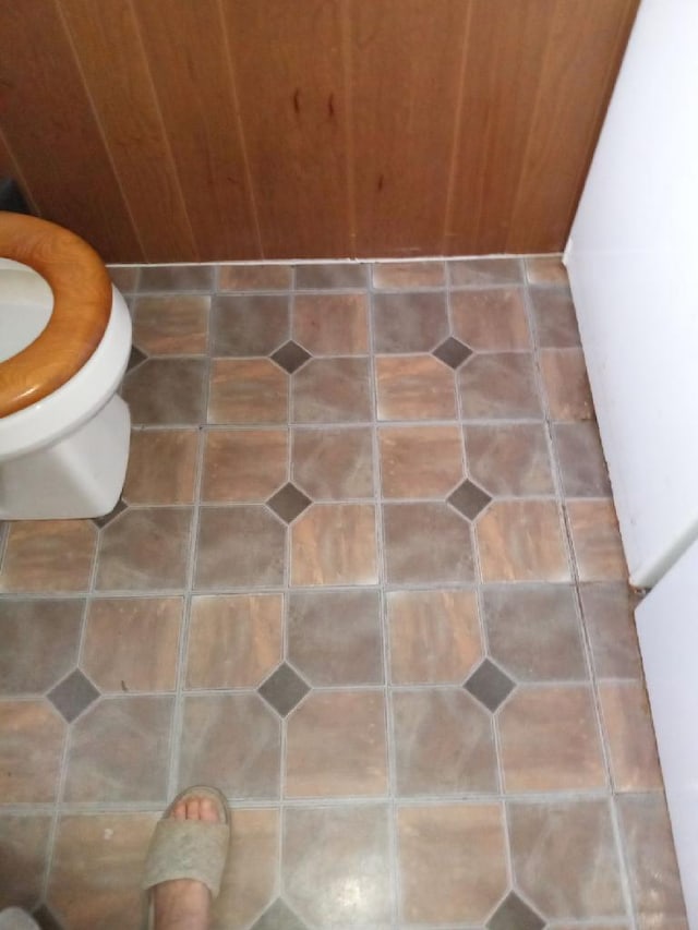 room details featuring toilet and tile floors