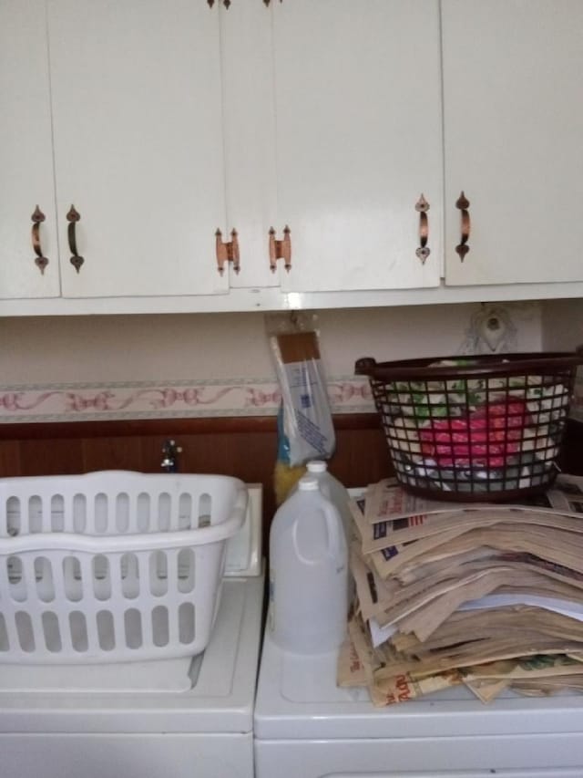 washroom featuring cabinets and independent washer and dryer