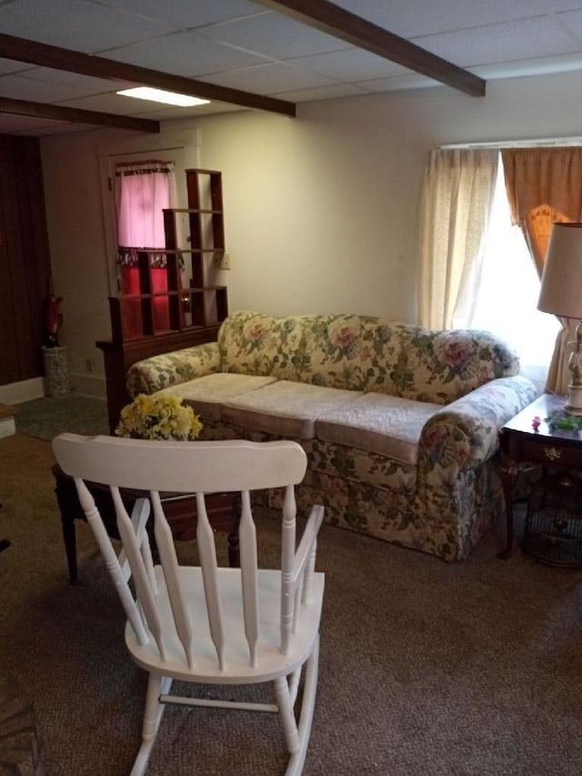 living room with dark colored carpet and beamed ceiling