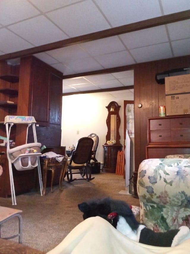 carpeted living room featuring a paneled ceiling