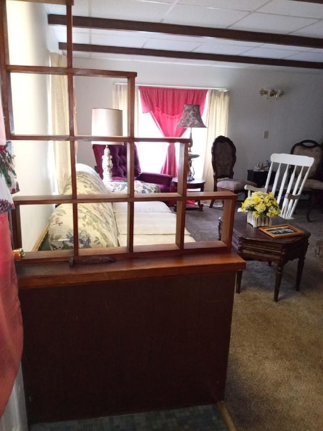 carpeted living room featuring a paneled ceiling