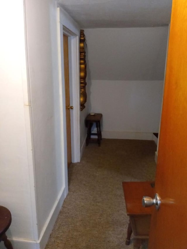 hallway featuring light colored carpet