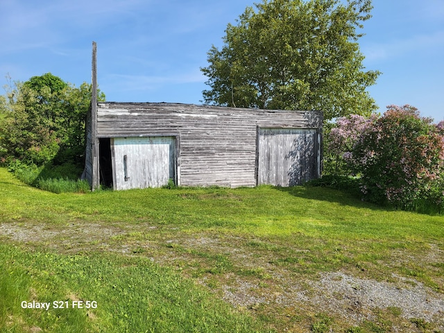 view of outdoor structure with a lawn