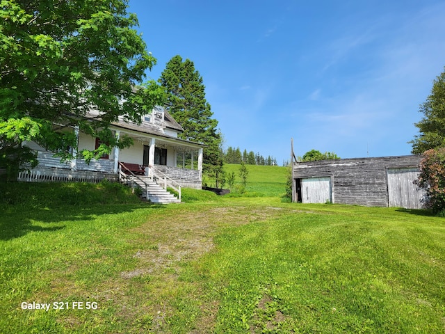 view of yard with covered porch