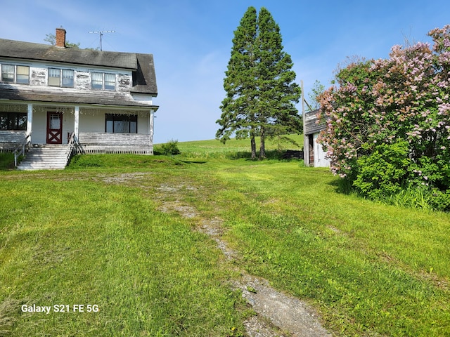 view of yard with covered porch