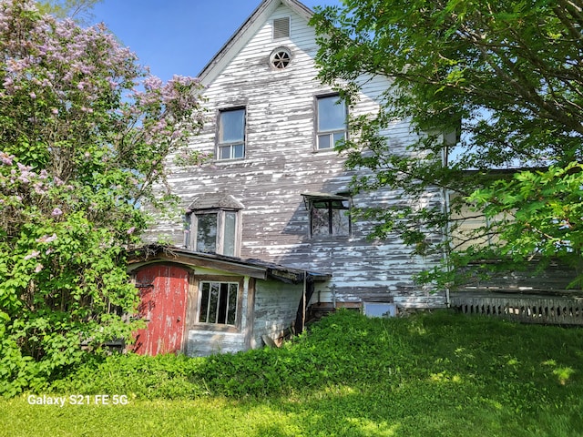 rear view of house with a yard