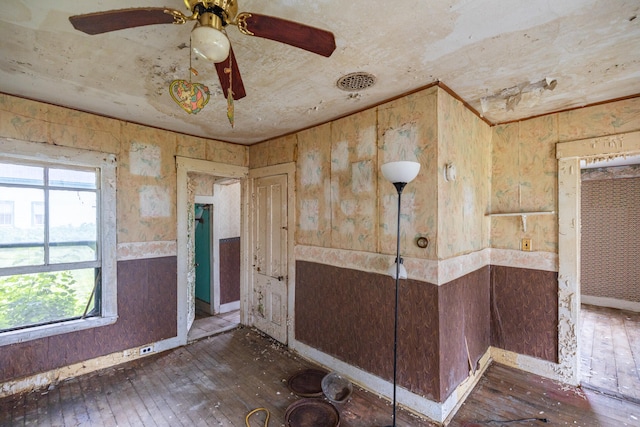 spare room featuring ceiling fan and dark wood-type flooring