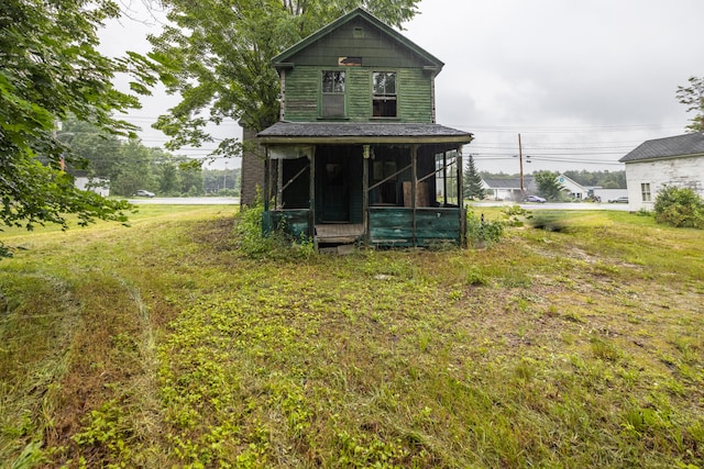 back of house with a lawn