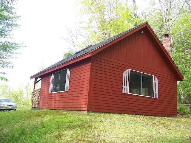 view of property exterior featuring a lawn