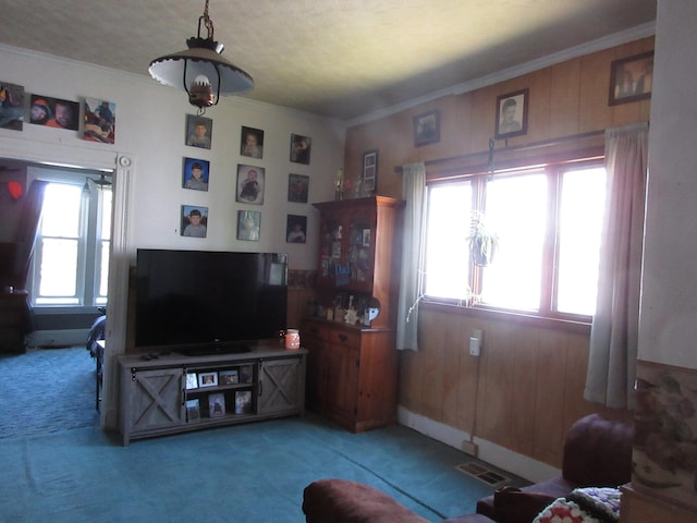 living room with crown molding and dark carpet