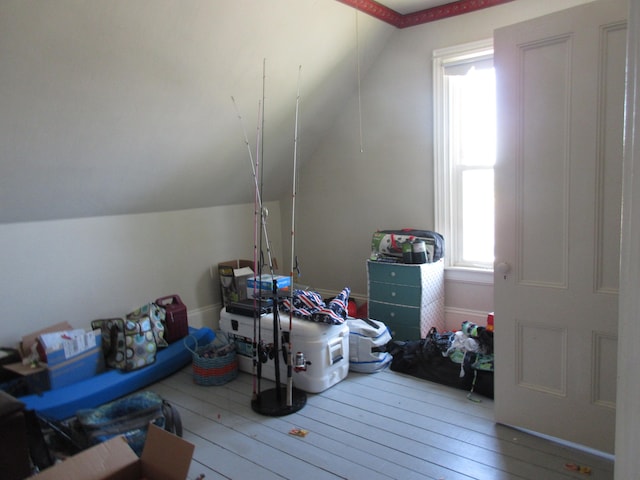 interior space featuring hardwood / wood-style flooring and vaulted ceiling