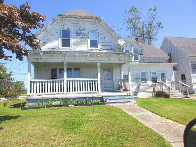 view of front of house with a front lawn and covered porch