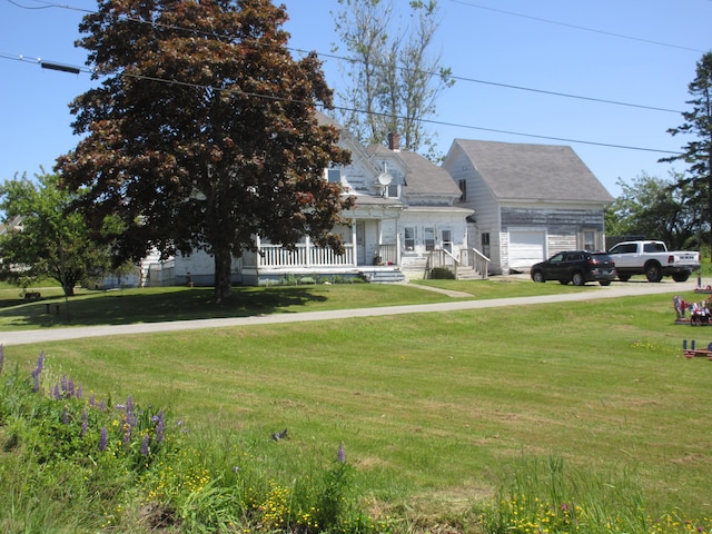 cape cod house with a porch, a front lawn, and a garage