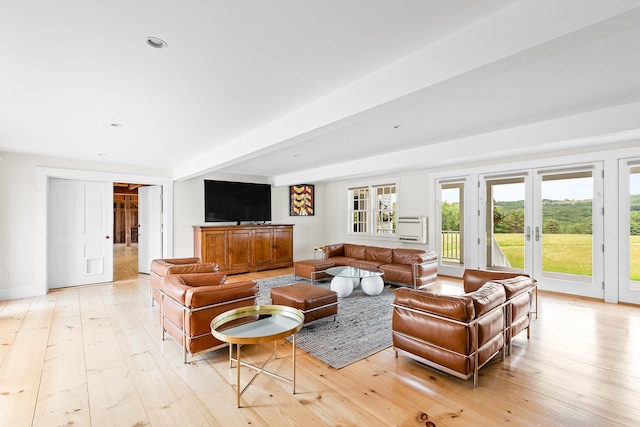 living room with beam ceiling and light hardwood / wood-style floors