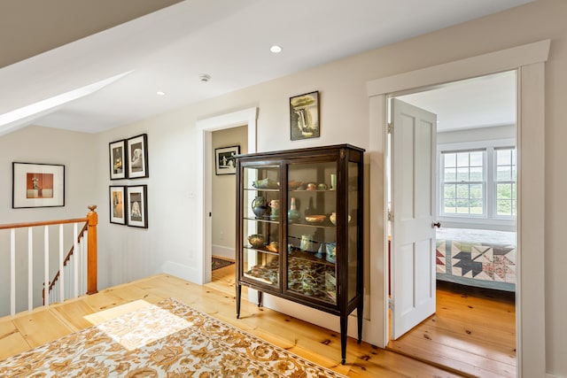 dining space featuring light hardwood / wood-style floors and a skylight