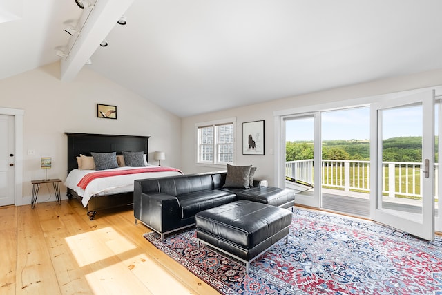 bedroom featuring beamed ceiling, rail lighting, access to exterior, light wood-type flooring, and high vaulted ceiling