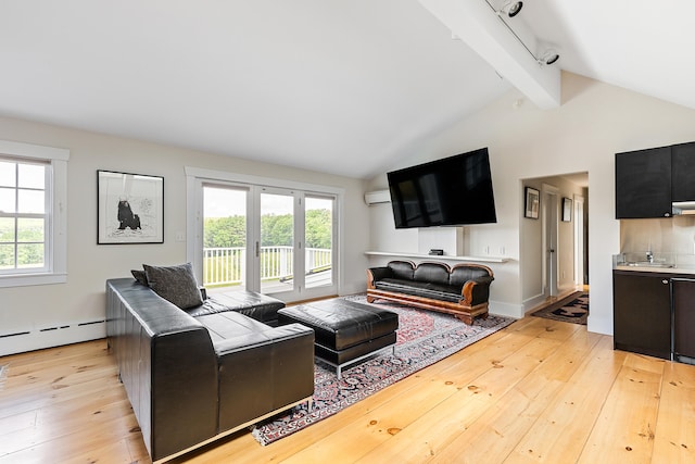 living room with plenty of natural light, track lighting, light hardwood / wood-style flooring, and lofted ceiling with beams