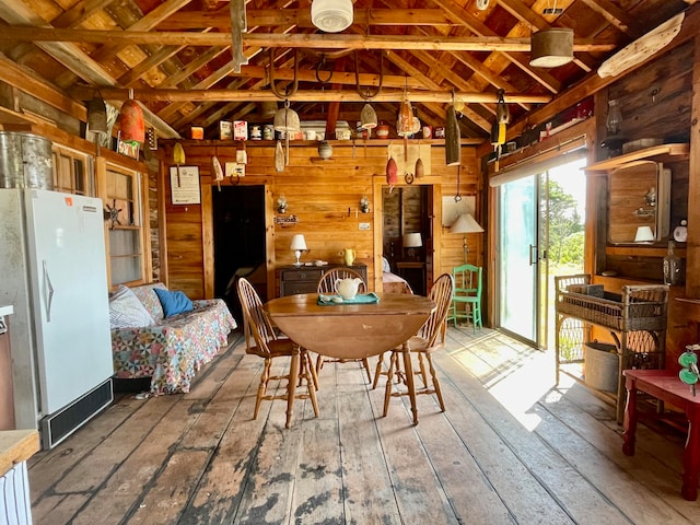 interior space with wood walls, light hardwood / wood-style floors, and french doors