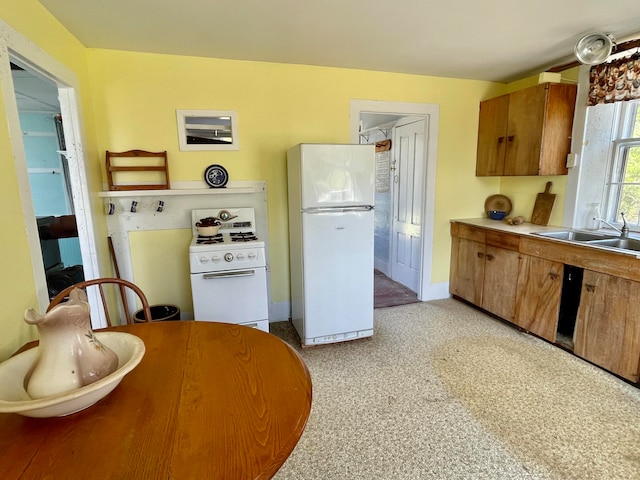 kitchen featuring sink and white appliances