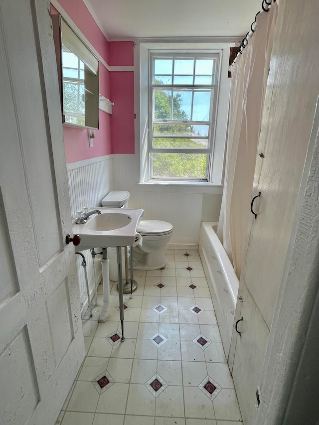 bathroom featuring tile flooring, toilet, and shower / bath combo