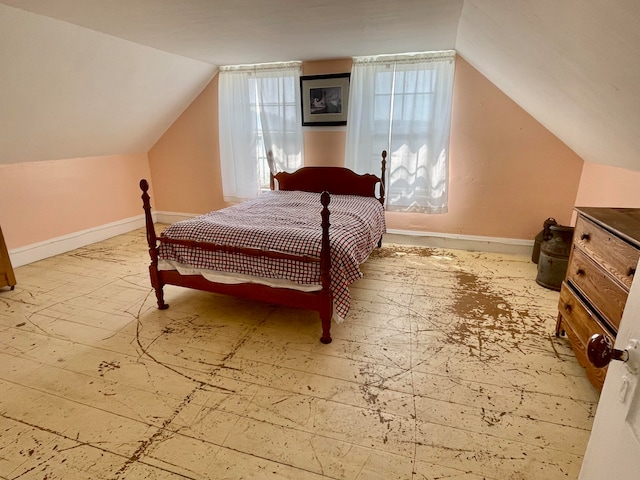 tiled bedroom featuring vaulted ceiling